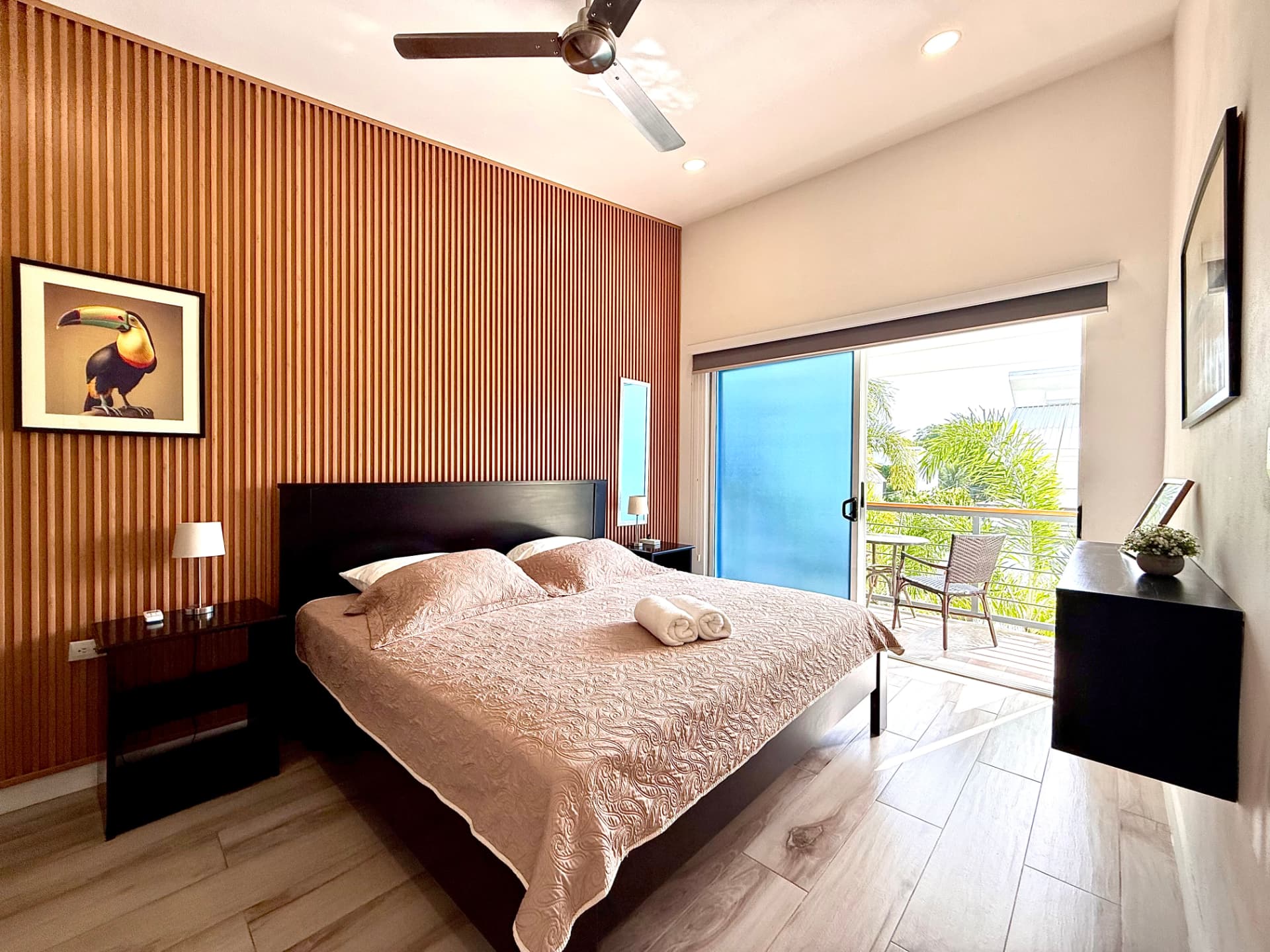Primary bedroom with king bed opening onto the private balcony