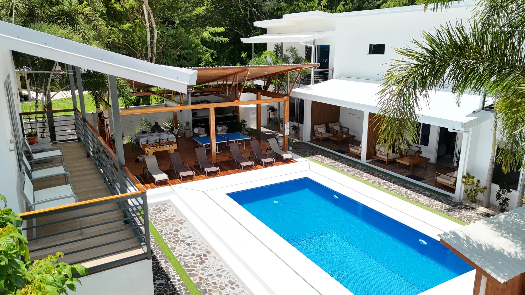 Elevated view across the shared pool, tropical courtyard and open-air gazebo