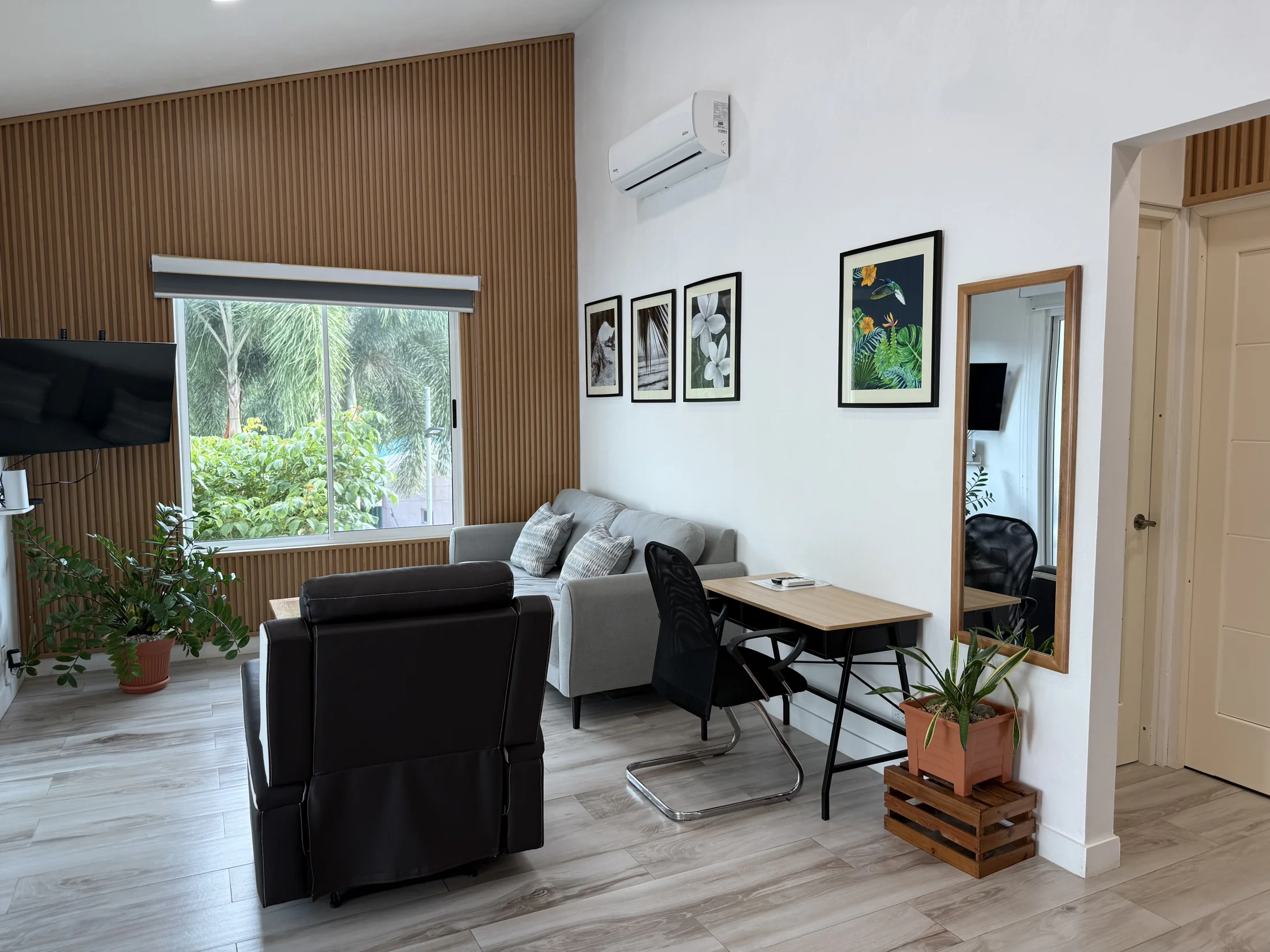 Comfortable general property living and workspace area with tropical artwork